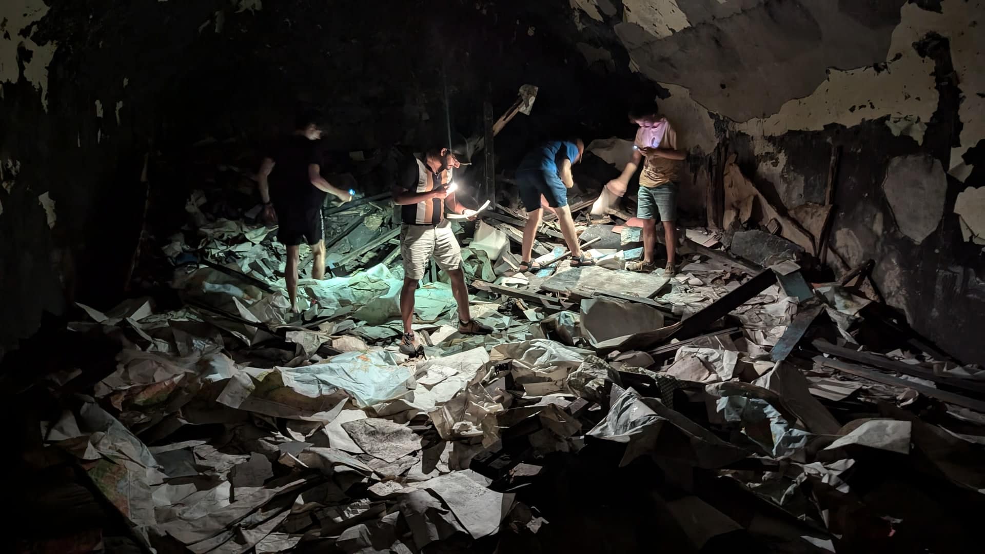 A photo of my friend on only military maps inside a dark bunker